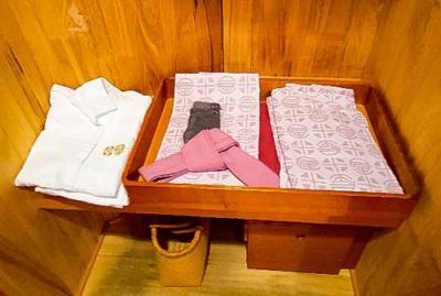 おとぎの宿米屋の金の刺繍のロゴ入り白いパジャマと薄いピンクの模様の浴衣と作務衣